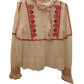 Cream-colored shirt with red embroidery