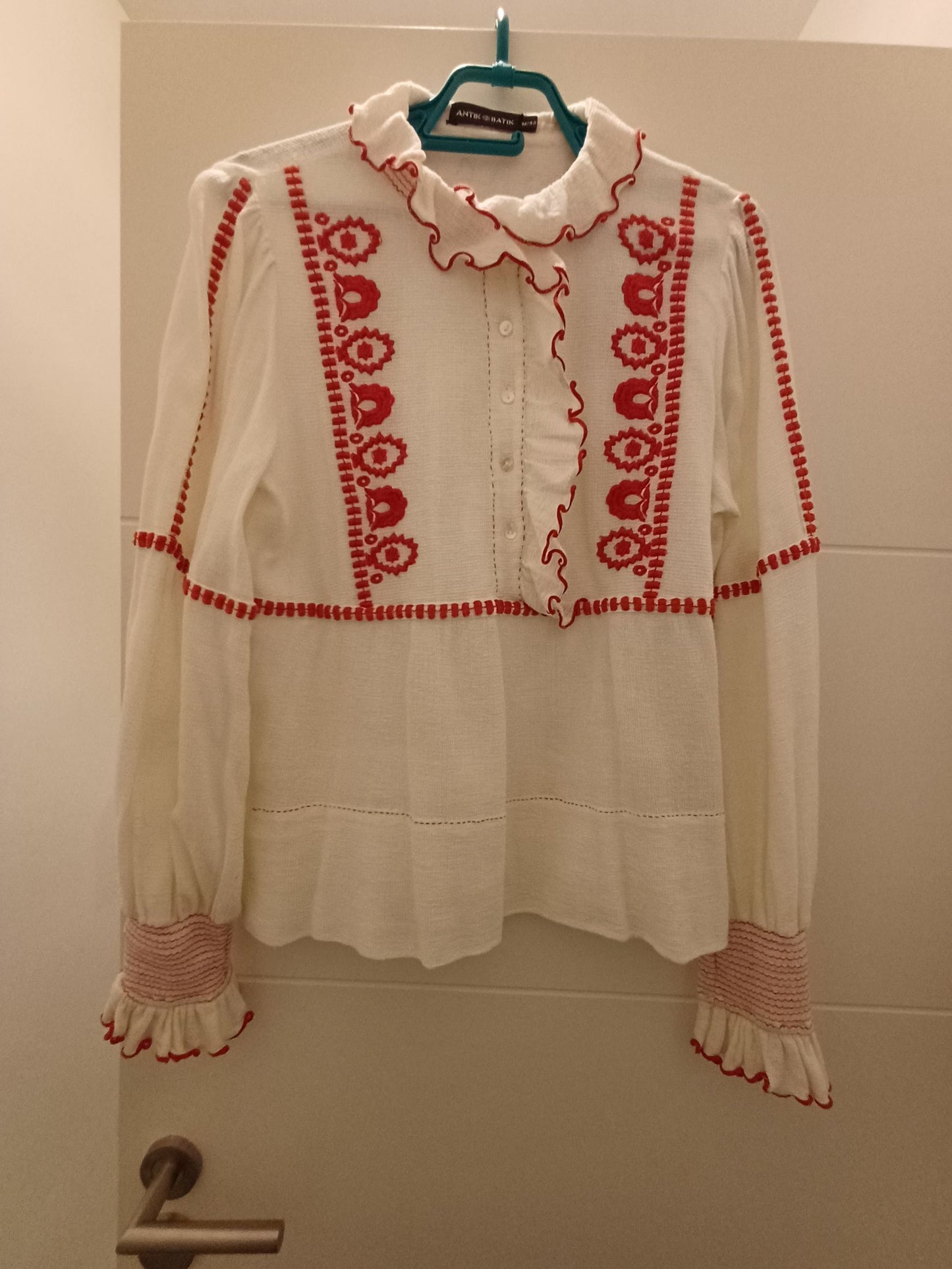 Cream-colored shirt with red embroidery